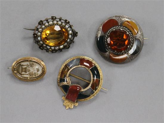 Two late 19th century Scottish hardstone brooches, a citrine and seed pearl brooch and an early 19th century mourning brooch.
